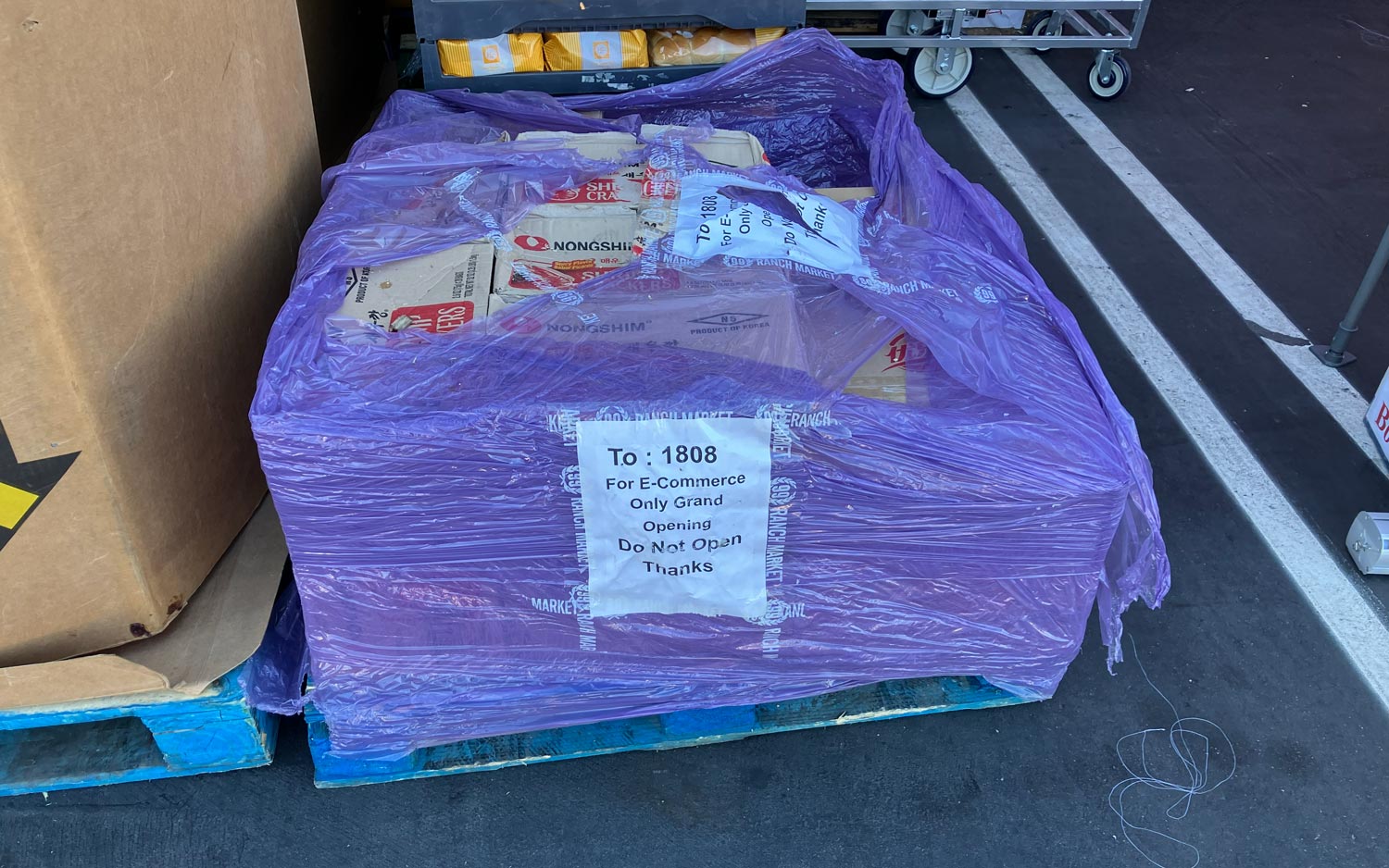 Pallet of e-commerce orders wrapped for transport at a warehouse loading dock